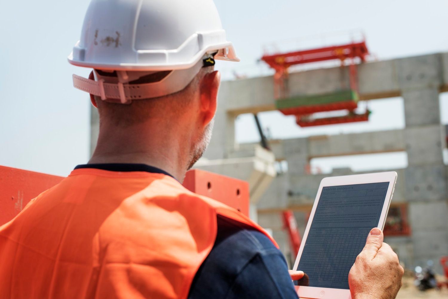 Construction professional reviewing work on a building site